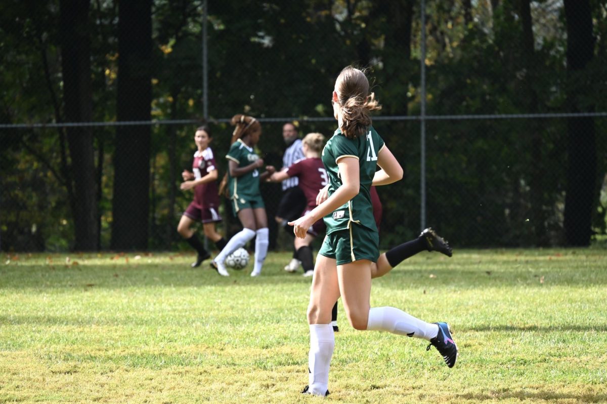 Staisy Biowott, '29 fights for the ball while Sarah Kuntz, '26 prepares for the chase. 