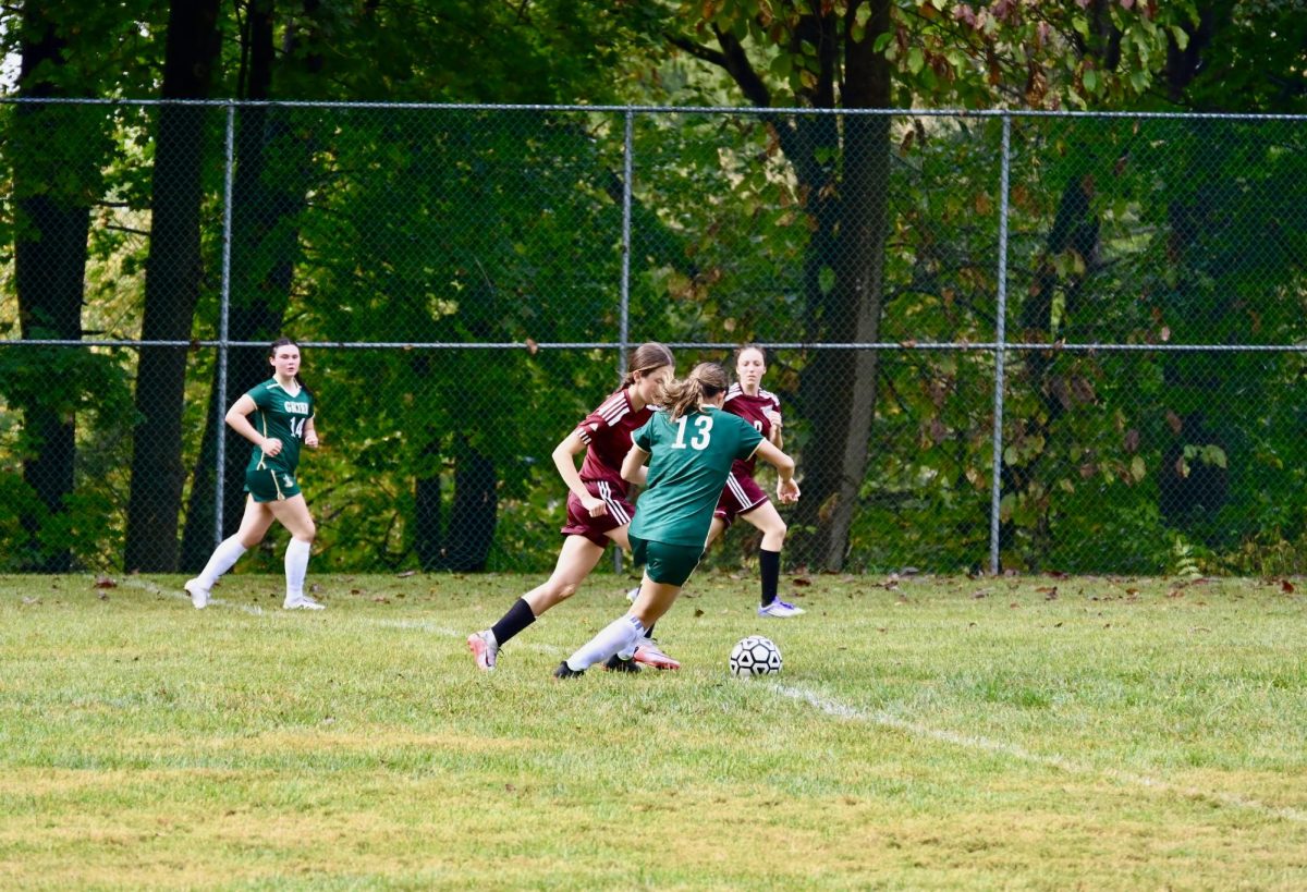 Marcela Molina Aguayo, '27 charges down the field while Kaylie McCabe, '30 prepares to support.
