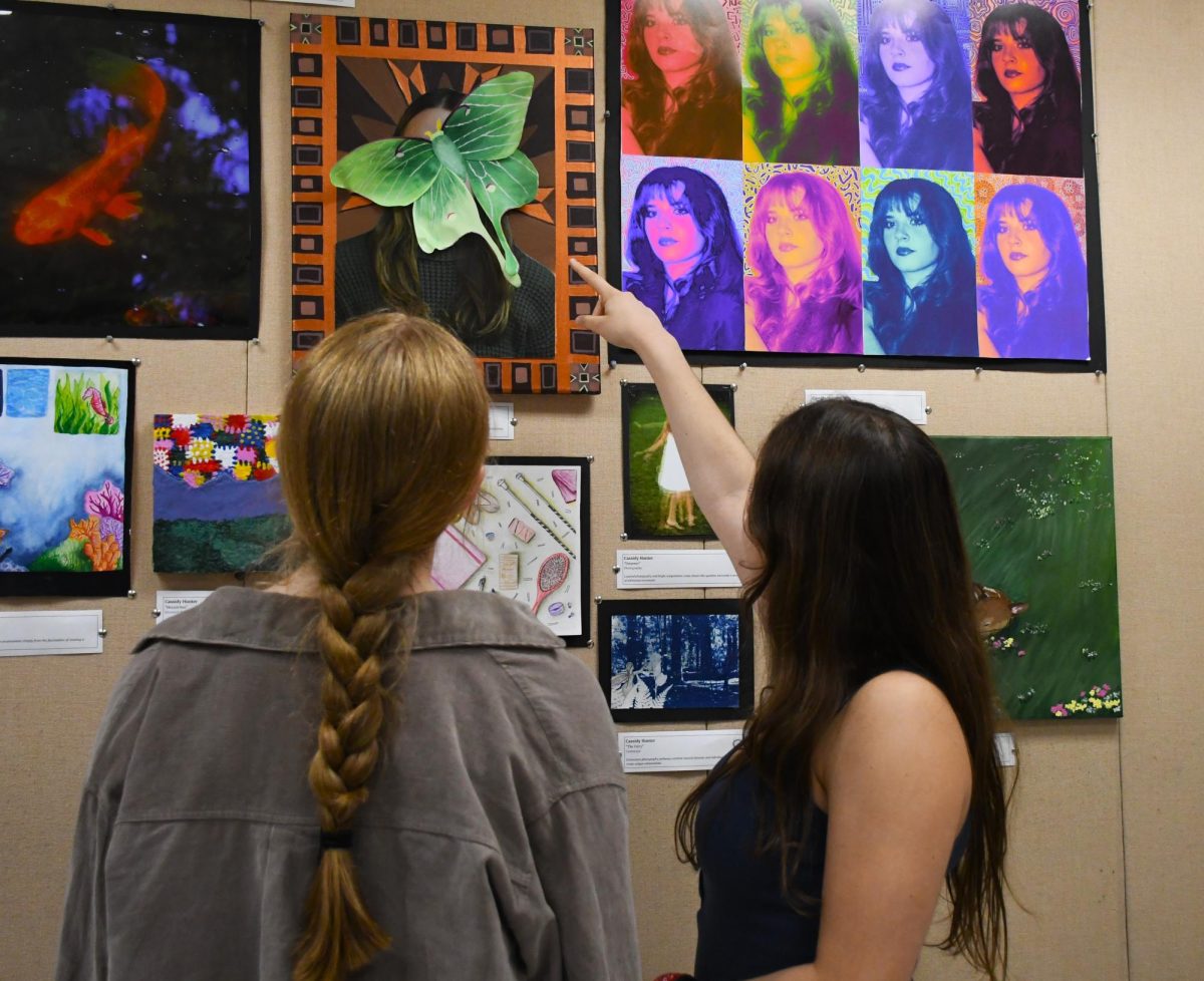 Some students viewing artwork at the AP art show!